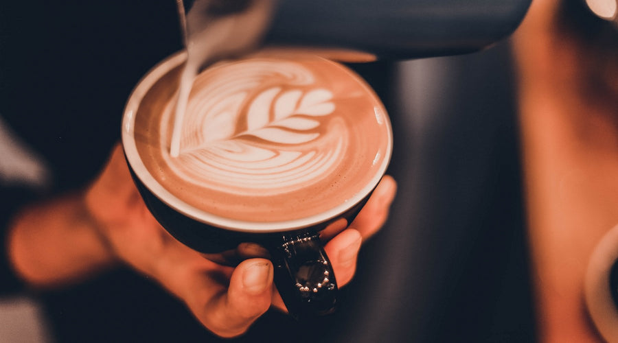 A barista-style coffee with some latté art on top.