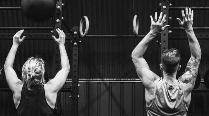 3CFitness man and a woman reaching up to exercise